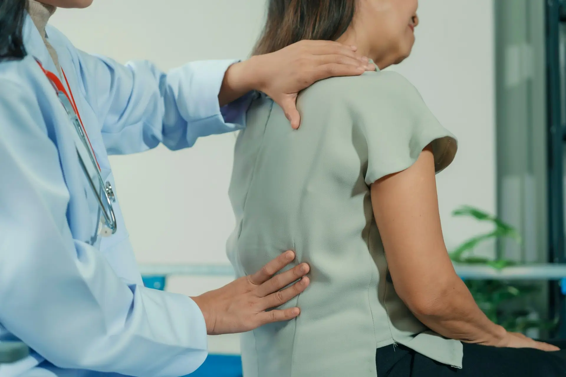A physician at Innovative Pain Care Center performing a physical back examination on a patient seeking sciatica pain relief.